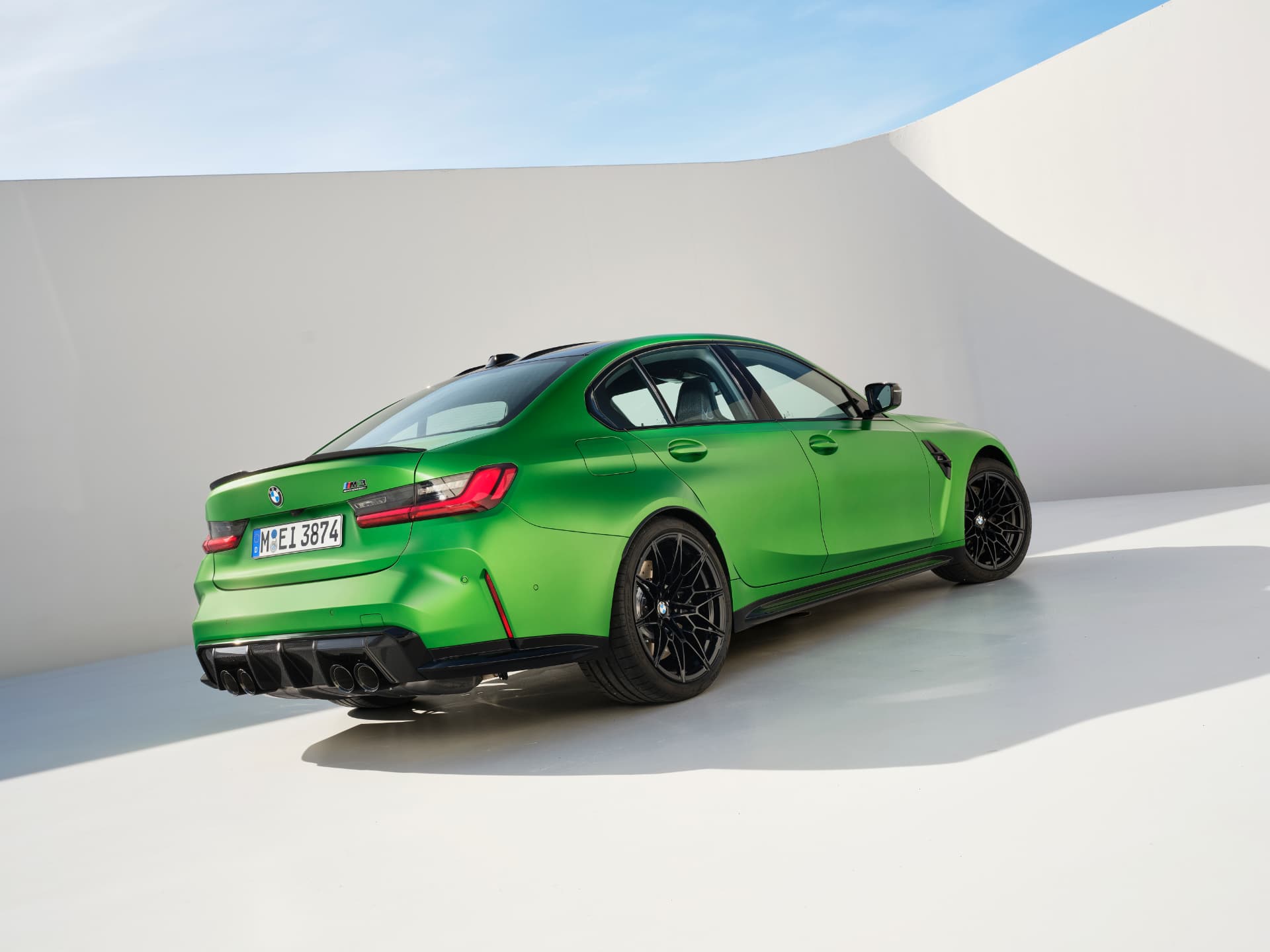 BMW M3 G80 sedan photographed from the rear three-quarter