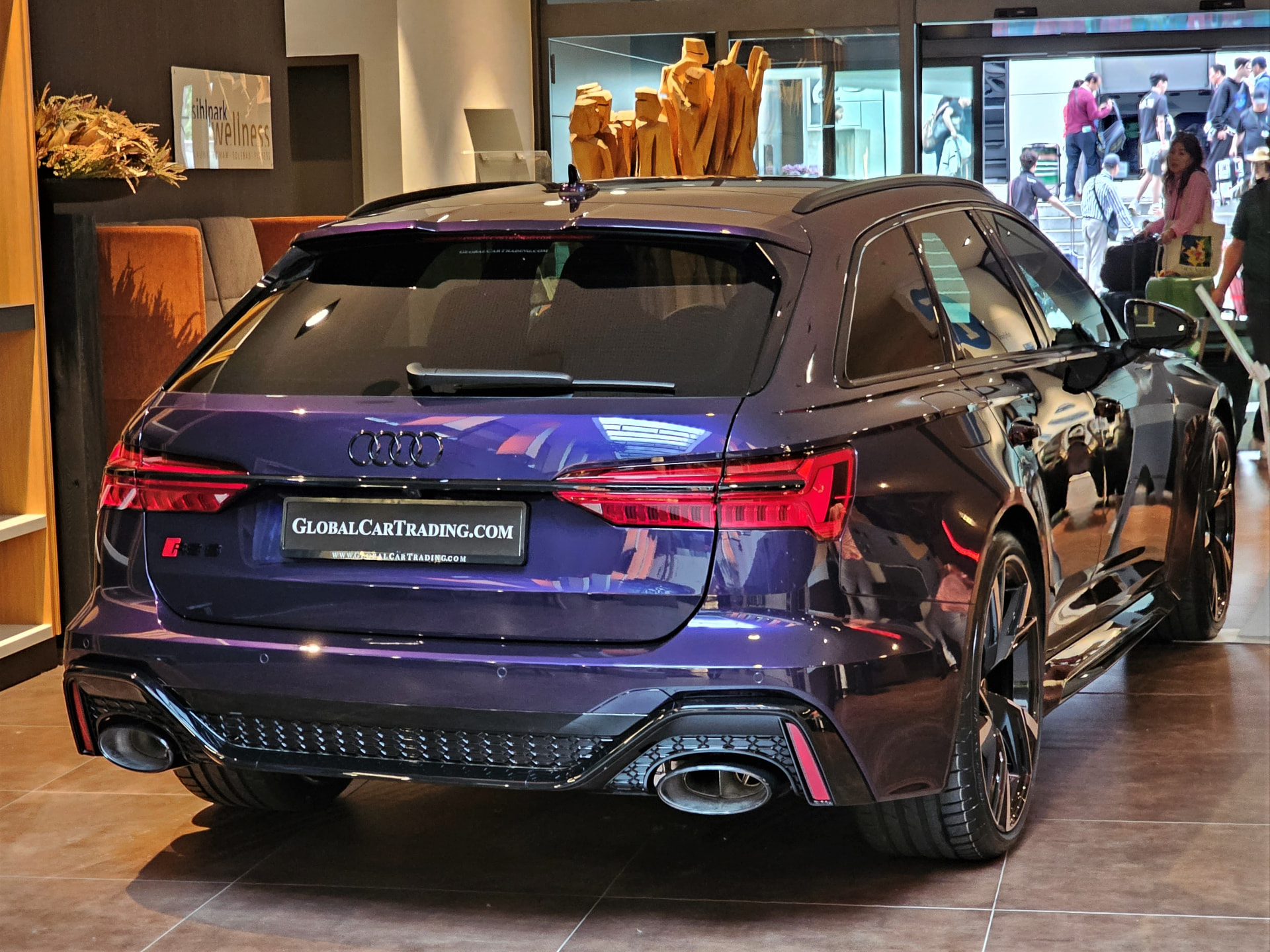 Audi RS6 Avant C8 in Merlin Purple, rear three-quarter view